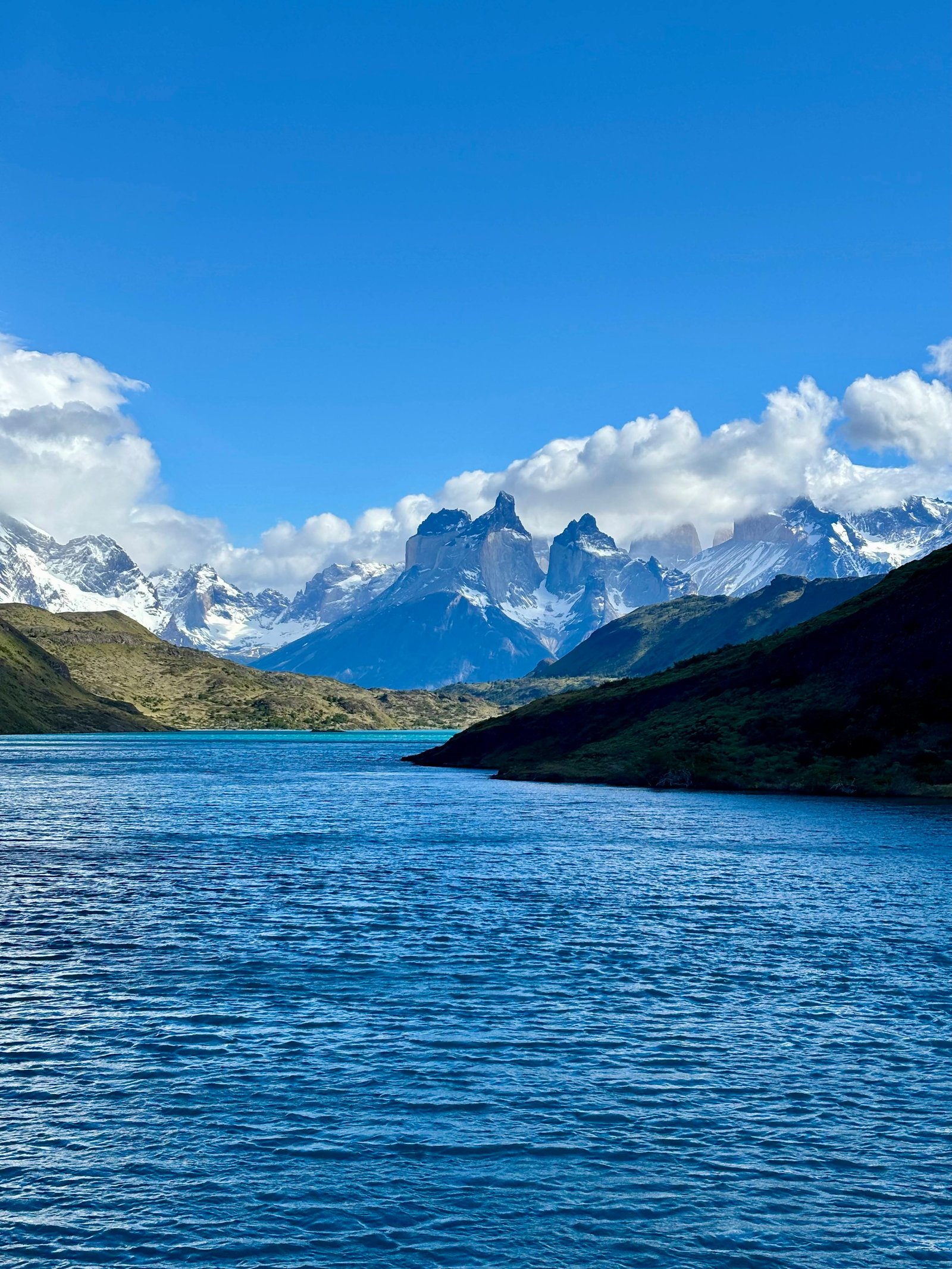 Dramatic peaks of Torres del Paine reflected in glacial water